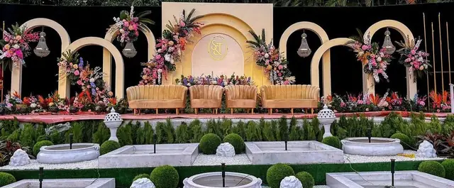 Floral arch couple sofa wedding Udaipur